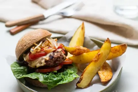 Cheeseburger med karameliseret løg og kartoffelbåde