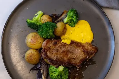 Citruskrydrede koteletter med ovnbagte kartofler, løg, broccoli og bearnaisesauce